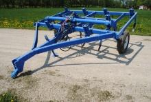 10-Shank Ripper with hydraulic lift, stored inside, has 7 new shovels on it.