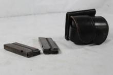 Two 22 cal magazines, some rust and one double leather speedloader holder. Used.