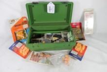 Green tackle box of shooting and hunting items.