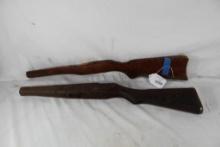 Two wood rifle stocks. One is damaged. Used.