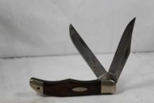 Case 1973 Folding Hunter with two 4 inch blades. Jigged wood scales. In good condition.