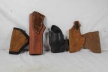 Four leather holsters. Used.