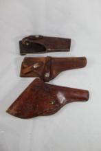 Three right handed leather holsters. One web belt flap and two belt holsters. Used.