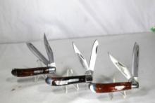 Two Imperial Schrade trapper knives with acrylic swirl and stainless steel blades, one Schrade