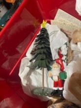 Three Bins Of Christmas Decor With Gift Tags