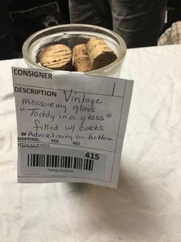 vintage measuring glass filled with corks