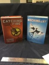 Two piece books by Suzanne Collins the Mockingjay and catching fire