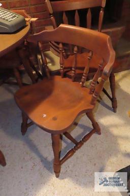 Maple table with three matching chairs and one extra chair, in basement