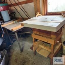 Homemade router table and workbench with wooden top and metal frame