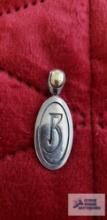 Two tone double-sided pendant one side engraved with the letter R or B....The other side has flowers
