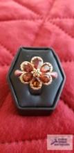 Two-tone floral ring with garnets,...marked 925 9.5 G... (Description provided by seller)