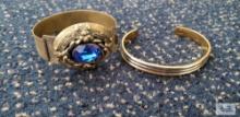 Brass colored blue gemstone bracelet and two-tone cuff bracelet