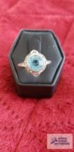 Silver colored ring with blue irradiated diamonds stone marked Sterling 4.0 G (Description provided