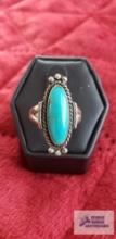 Silver colored ring with oval turquoise colored stone marked Sterling 4.3 G (Description provided by