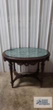 Antique carved mahogany table with green marble insert. 30-1/2 in. tall by 38-1/2 in. long by 26 in.
