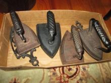 Four Antique Cast Iron Sad Irons and Two Trivets