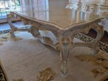 SILIK MINERVA DINING ROOM TABLE WITH GLASS TOP. STENCILED DETAILING ON TOP. CARVED/FLORAL DETAILING.
