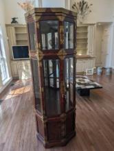 LATE 19TH CENTURY KOREAN BRASS ACCENTED OCTAGON SHAPED LIGHTED CURIO CABINET WITH MIRRORED BACK.