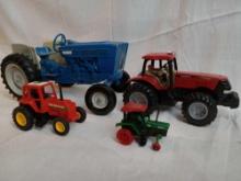 Lot of toy tractors. Includes Blue Ertl Cast Iron Tractor, Tonka and 2 others. The largest tractor