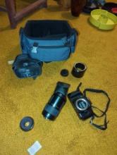 (LR) OLYMPUS OM88 CAMERA WITH ATTACHMENTS AND CARRY BAY, 70-210 AF ZOOM LENS, AND 49MM SKYLIGHT LENS