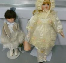 TWO PORCELAIN DOLLS ON STANDS