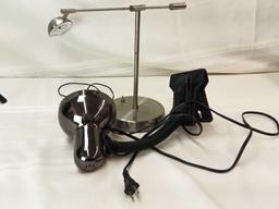 DESK LAMPS. SILVER ONE WORKS, IS ADJUSTABLE, BLACK ONE IS CLIP-ON STYLE UNTESTED.