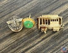 (2) gold charms and (1) gold pin