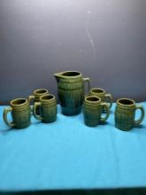 McCoy stoneware pottery pitcher and six mucks