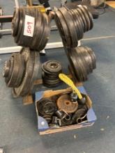 Metal weight rack with lots of weight. different size bar weights