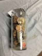 vintage measuring glass filled with corks
